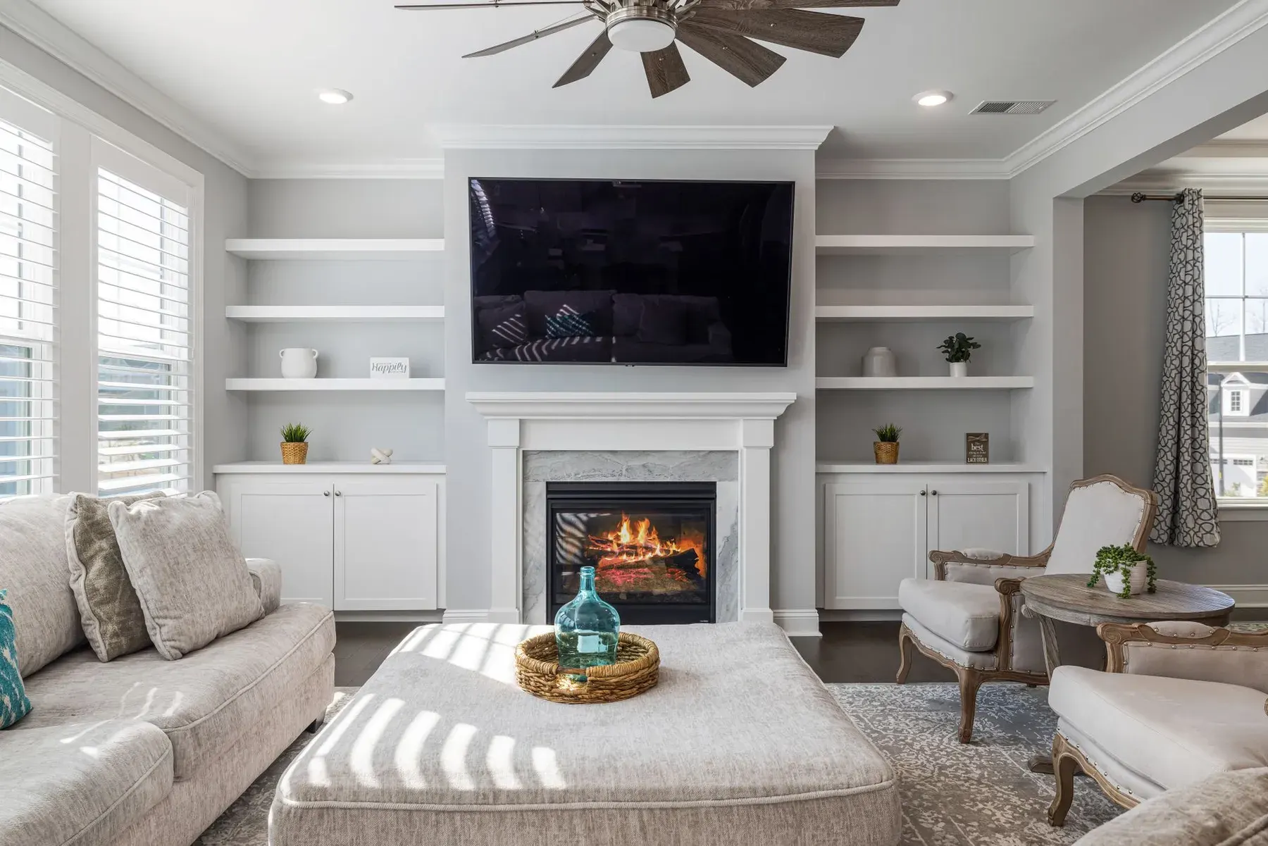 White built-in cabinetry around a fireplace and TV in a living room